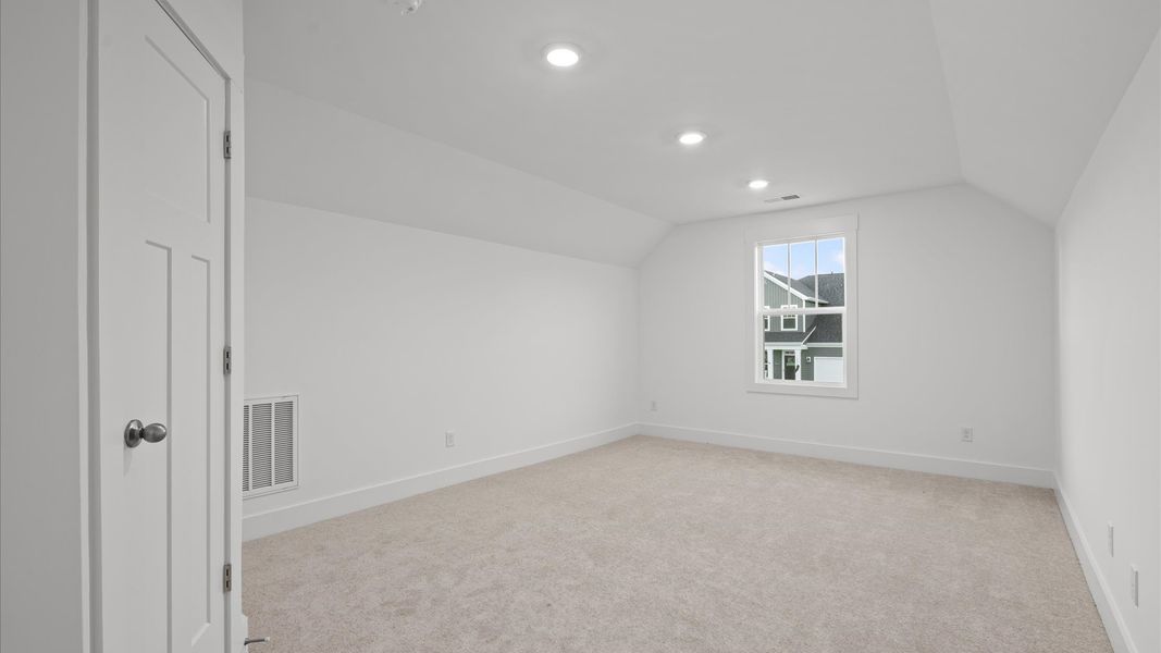 Accomplished design shines in this carpeted bedroom with a functional walk-in closet