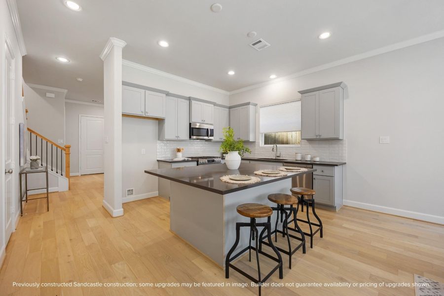 An alternate view unveils the kitchen’s grand island, serving as the heart of the home, with an inviting passage to the adjacent dining room, where memories await to be made. An alternate view unveils the kitchen’s grand island, serving as the heart of the home, with an inviting passage to the adjacent dining room, where memories await to be made.