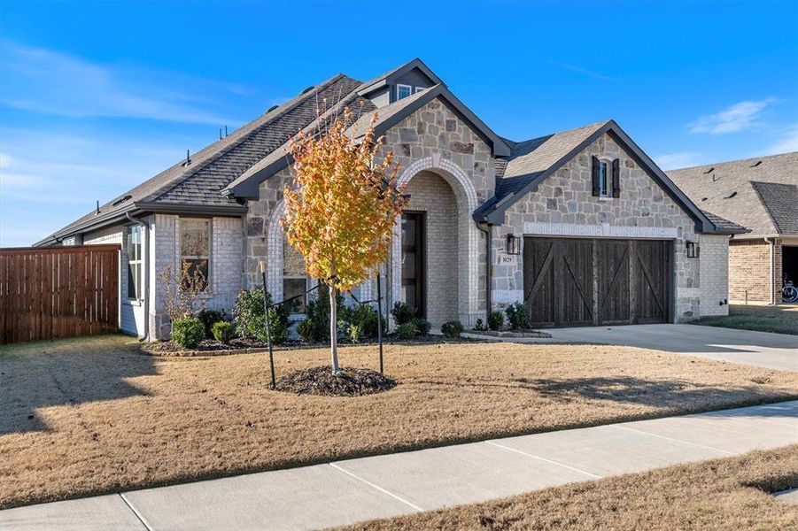 Front exterior of a new home in The Grove, Midlothian, TX, highlighting curb appeal (Image 23).
