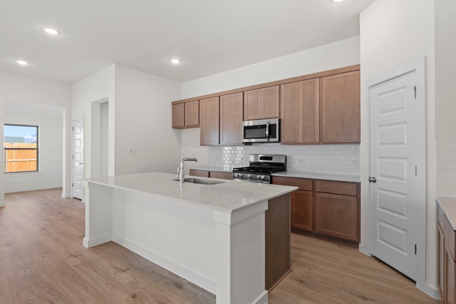 Kitchen in the Quartz home plan by Trophy Signature Homes – REPRESENTATIVE PHOTO