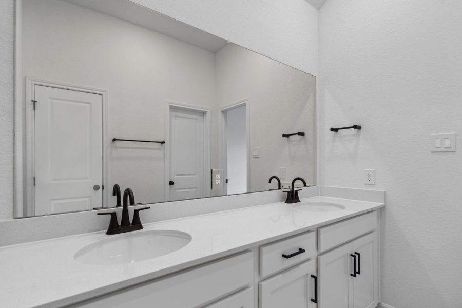 The en-suite bathroom offers a spa-like atmosphere with its elegant design, high end finishes, and tasteful lighting, creating a retreat within your own home. The en-suite bathroom offers a spa-like atmosphere with its elegant design, high end finishes, and tasteful lighting, creating a retreat within your own home.