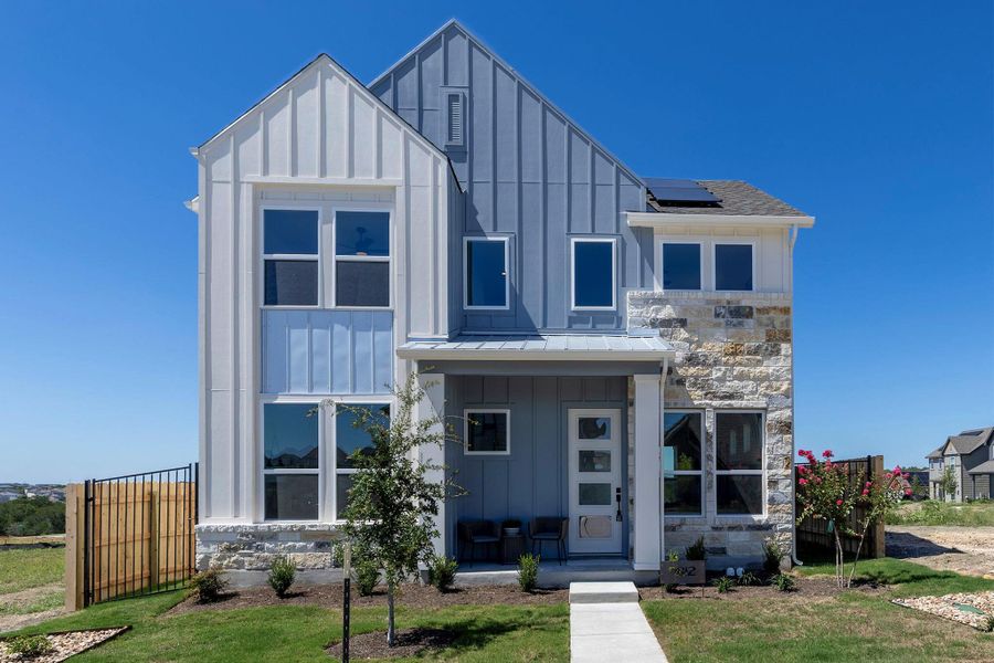 Front exterior of a new home in Whisper Valley, Manor, TX, highlighting curb appeal (Image 2). Front exterior of a new home in Whisper Valley, Manor, TX, highlighting curb appeal (Image 2).