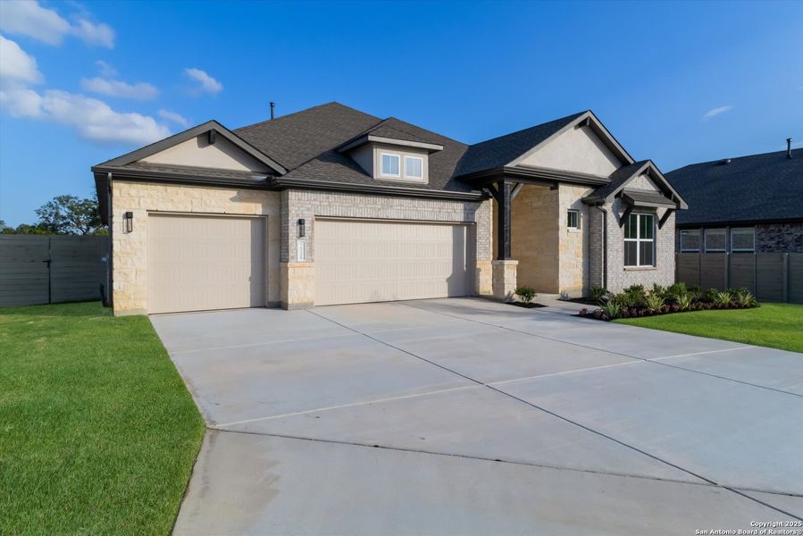 Front exterior of a new home in The Grove at Vintage Oaks, New Braunfels, TX, highlighting curb appeal (Image 14).