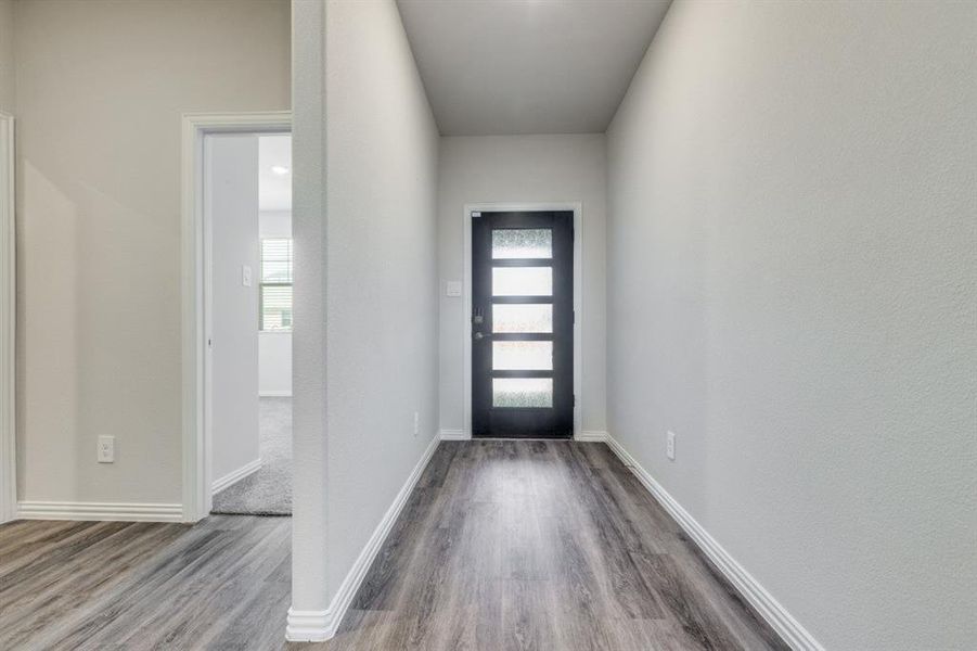 Foyer featuring baseboards and wood finished floors