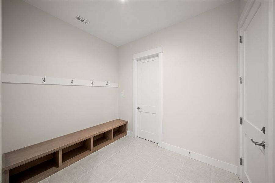 Mudroom featuring baseboards and light tile patterned flooring