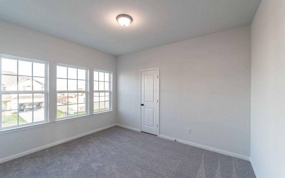 Carpeted empty room with baseboards