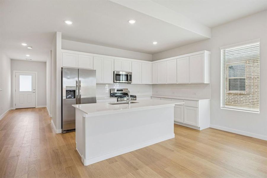 Kitchen in the Stanley II home plan by Trophy Signature Homes – REPRESENTATIVE PHOTO