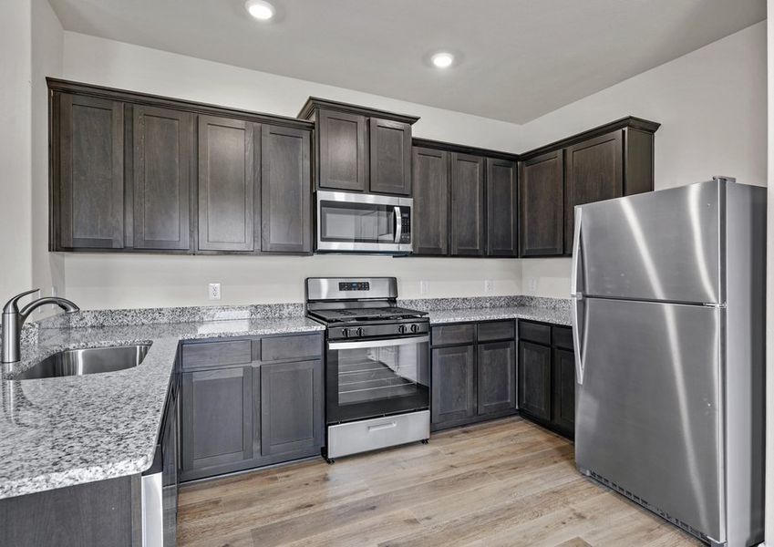 The kitchen has sprawling granite countertops.