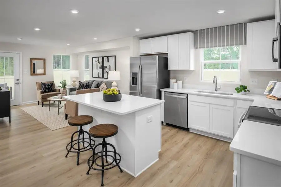 Representative furnished interior of a home built from the Beech by Ryan Homes in Highland Park Condos, White House (Image 6).