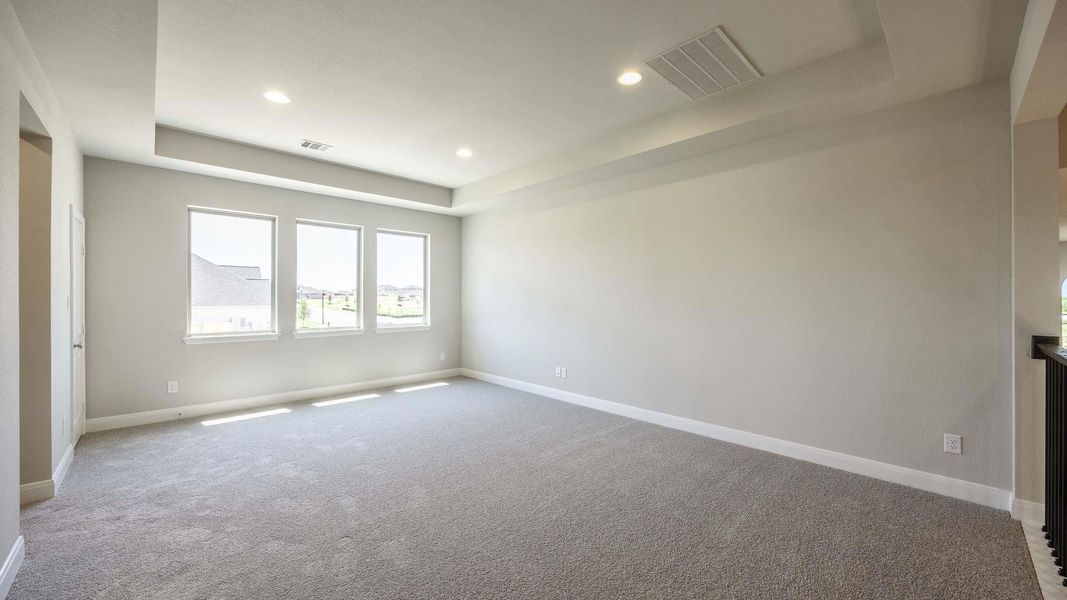 Empty room featuring a raised ceiling, carpet flooring, baseboards, and recessed lighting Empty room featuring a raised ceiling, carpet flooring, baseboards, and recessed lighting