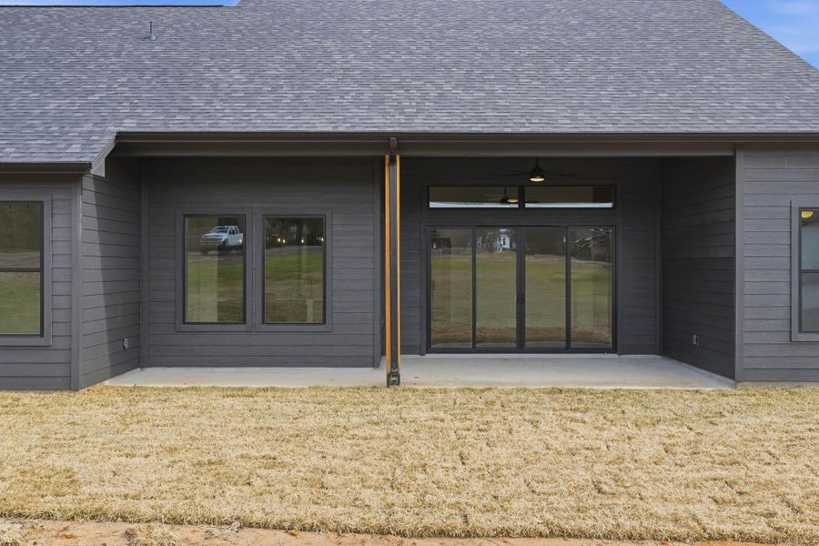 Covered back patio ideal for relaxing or entertaining, overlooking the expansive backyard with endless possibilities.
