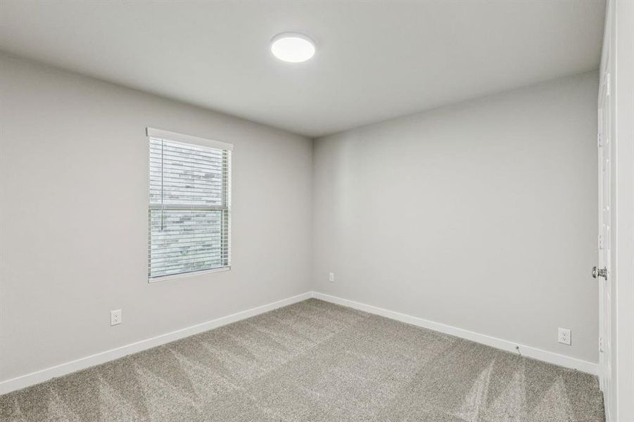 Bedroom in the Harper home plan by Trophy Signature Homes – REPRESENTATIVE PHOTO