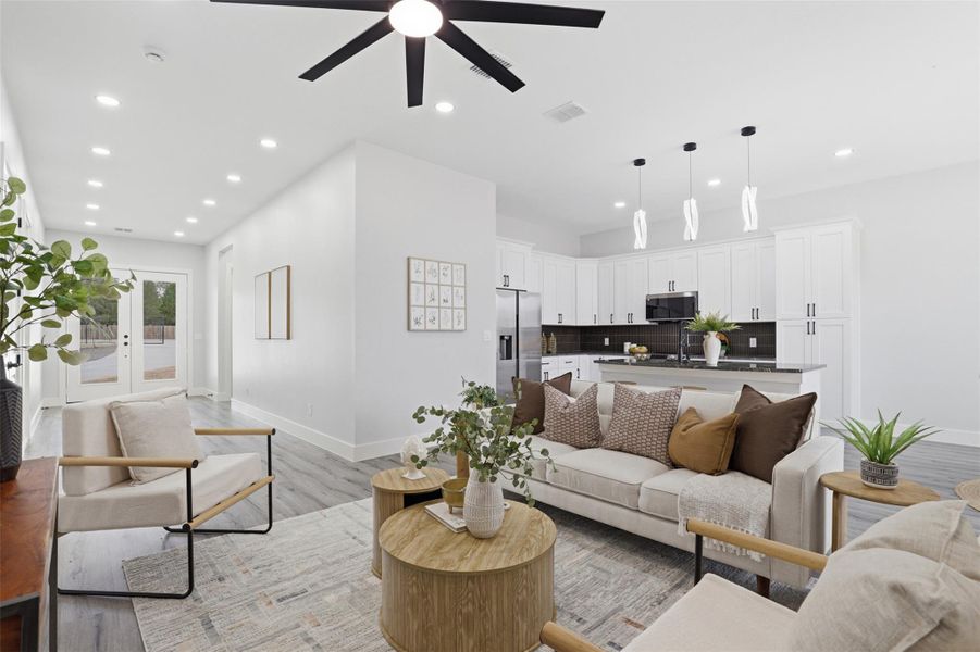 Open-concept living space with recessed lighting and wood-finish flooring