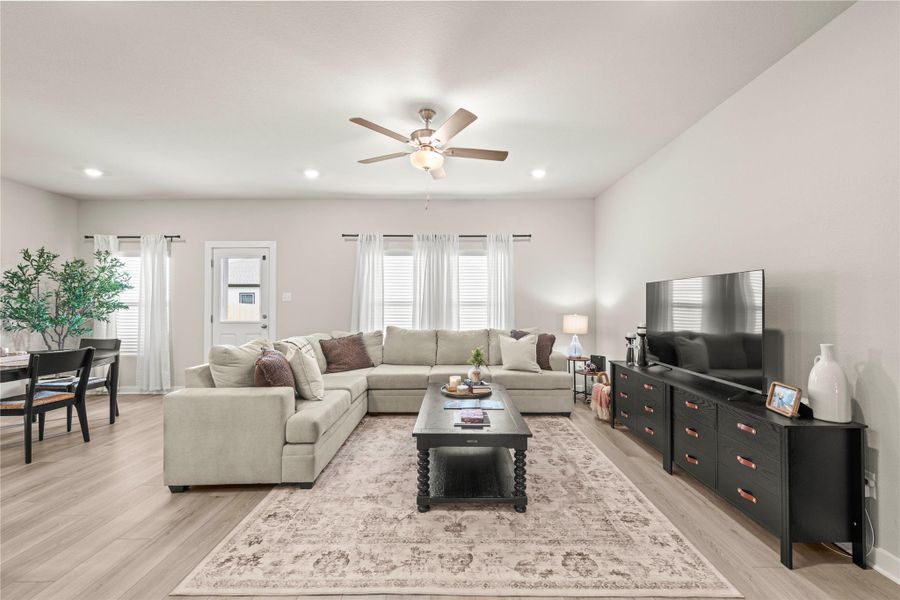 Natural light illuminates this living area featuring plank flooring and recessed lighting. Natural light illuminates this living area featuring plank flooring and recessed lighting.