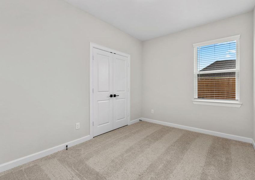 Windows let in plenty of light to this secondary bedroom.