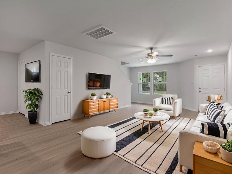 Modern living area with ceiling fan, featuring stylish virtual staging for a welcoming ambiance.