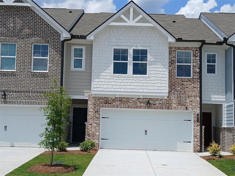 Front exterior of a new home in Union Village, McDonough, GA, highlighting curb appeal (Image 2).