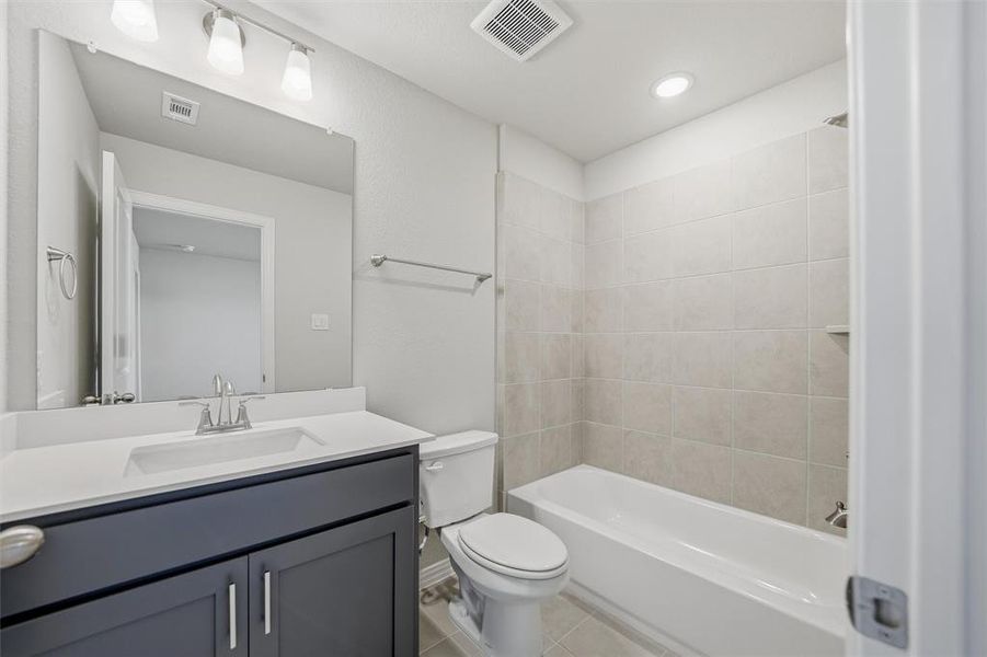 Full bathroom with vanity, shower / tub combination, light tile patterned floors, and recessed lighting Full bathroom with vanity, shower / tub combination, light tile patterned floors, and recessed lighting