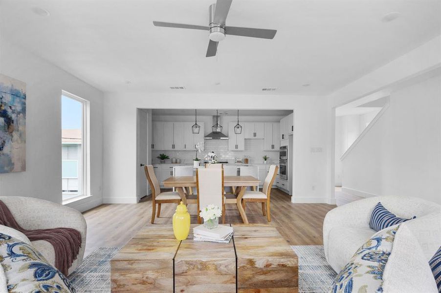 Dining space with light hardwood / wood-style flooring and ceiling fan