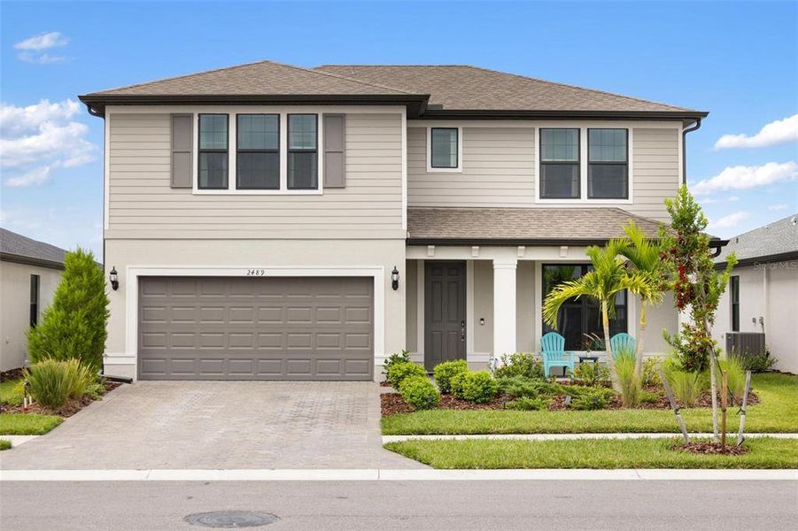 Front exterior of a new home in , North Port, FL, highlighting curb appeal (Image 1).