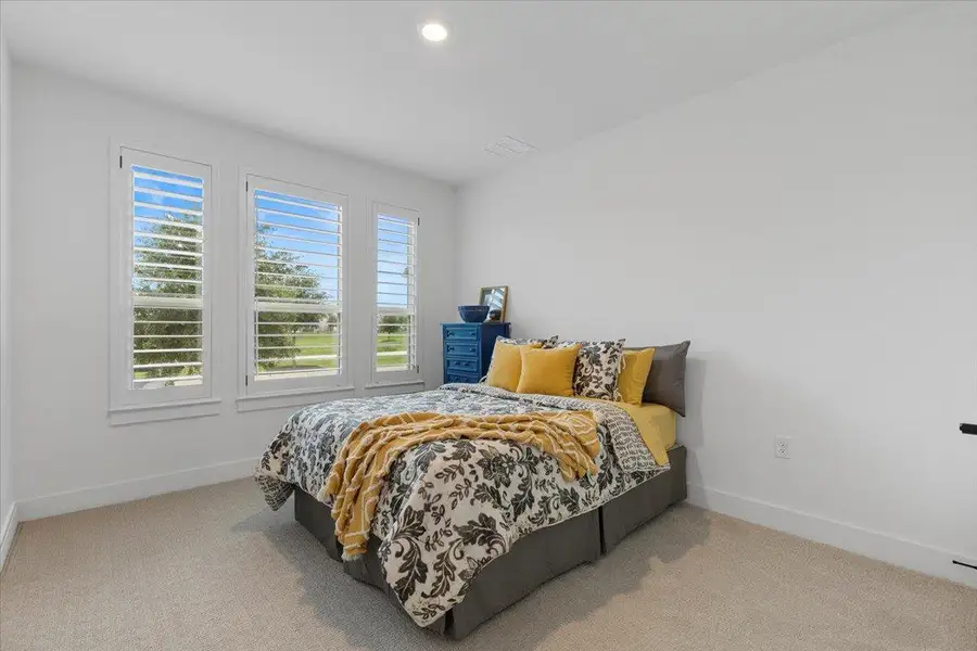 Carpeted bedroom featuring baseboards and recessed lighting