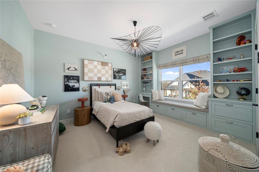 Bedroom featuring light carpet