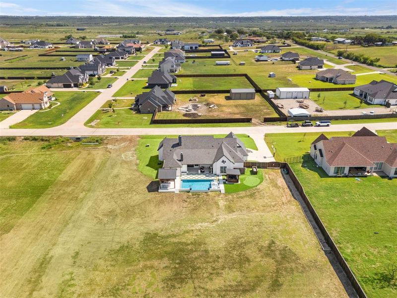Aerial view of property and neighborhood.