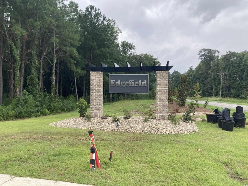 Community / neighborhood sign with a yard