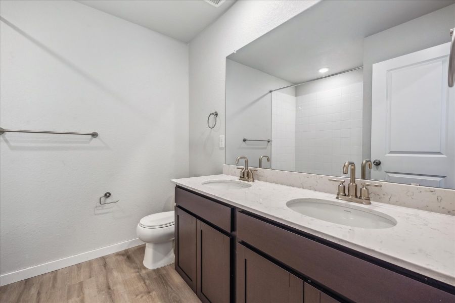 A bathroom with a large mirror. A bathroom with a large mirror.