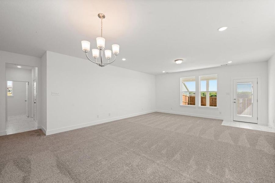 Dining area with decorative lighting and carpet