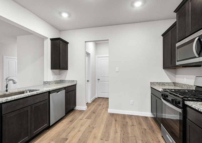 The kitchen has sprawling granite countertops.