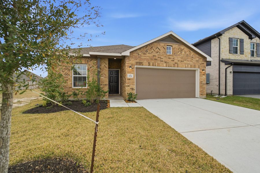 Front exterior of a new home in Windrose Green, Angleton, TX, highlighting curb appeal (Image 17). Front exterior of a new home in Windrose Green, Angleton, TX, highlighting curb appeal (Image 17).