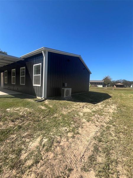 View of property exterior with a lawn and board and batten siding View of property exterior with a lawn and board and batten siding