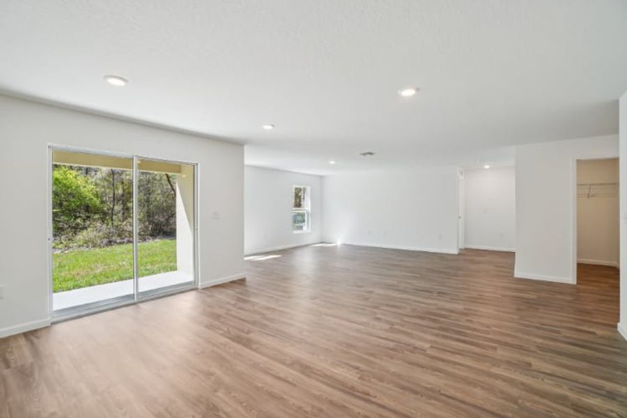 A room with a wood floor and a large glass door.