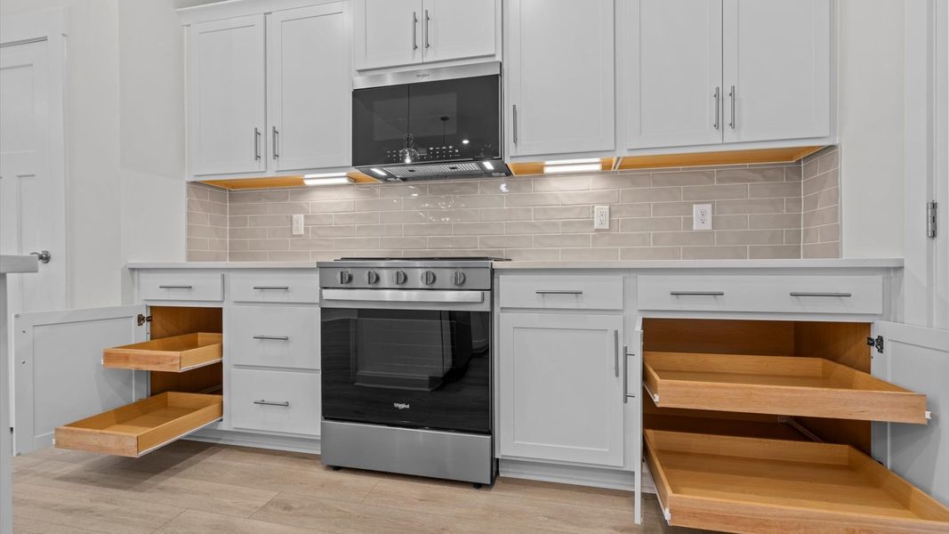 Memorable meals begin in this vibrant kitchen with pendant lighting and a thoughtfully designed island Memorable meals begin in this vibrant kitchen with pendant lighting and a thoughtfully designed island