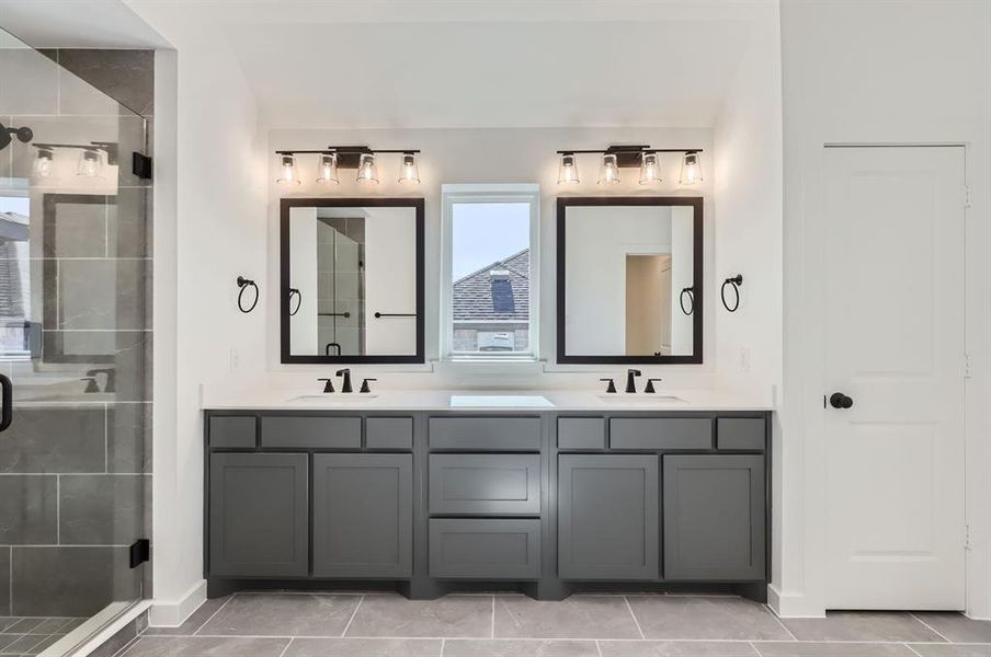 Bathroom featuring an enclosed shower, vanity, and tile patterned floors