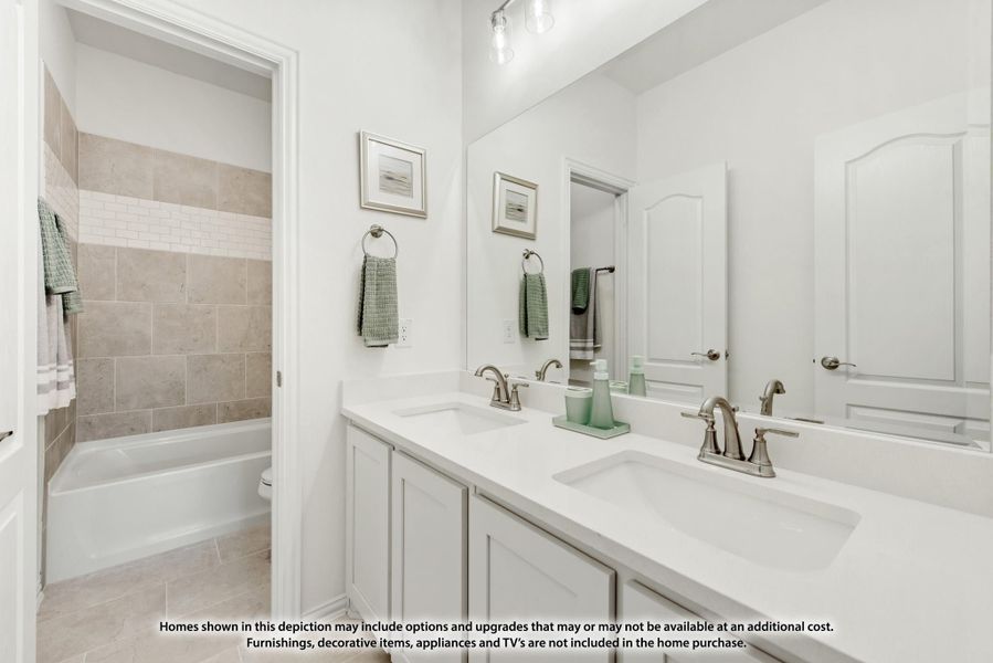 Bathroom with double sink vanity, large mirror, and tiled tub-shower combo with white walls Bathroom with double sink vanity, large mirror, and tiled tub-shower combo with white walls