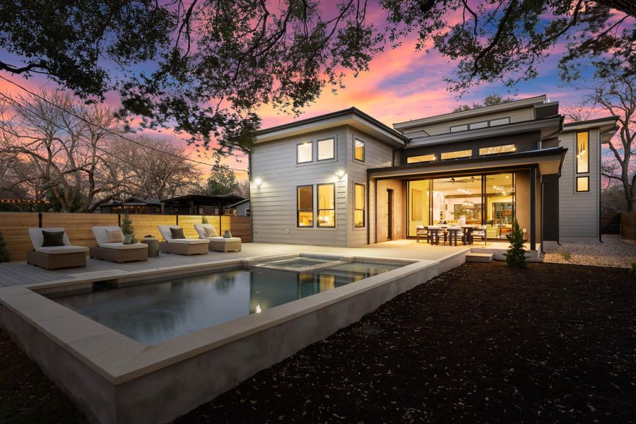 Rear view of house featuring a patio area, a pool with connected hot tub, and outdoor lounge area