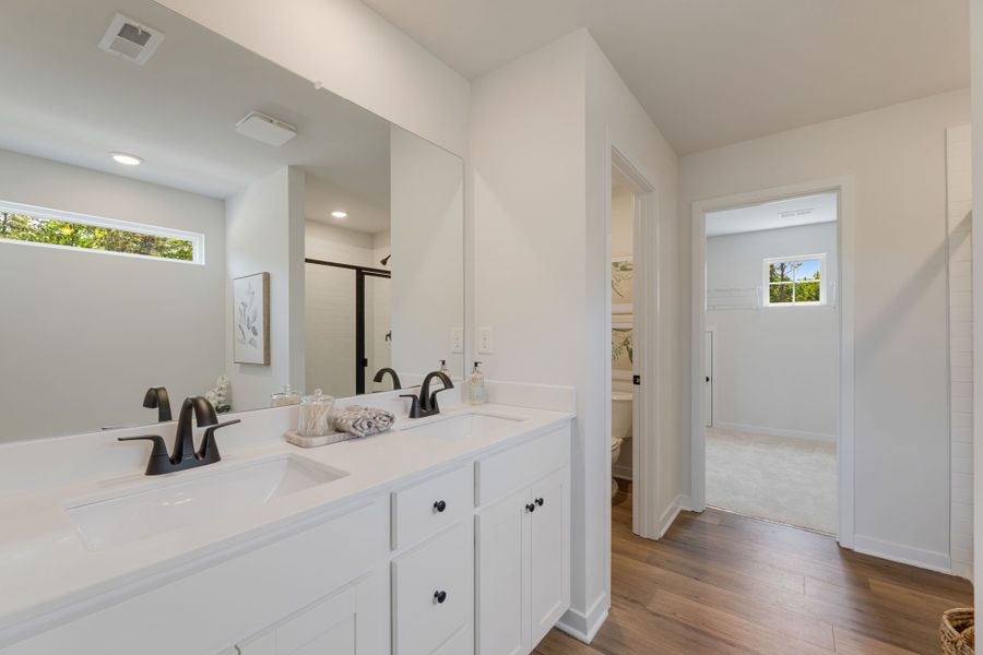 A bathroom with white cabinets. A bathroom with white cabinets.