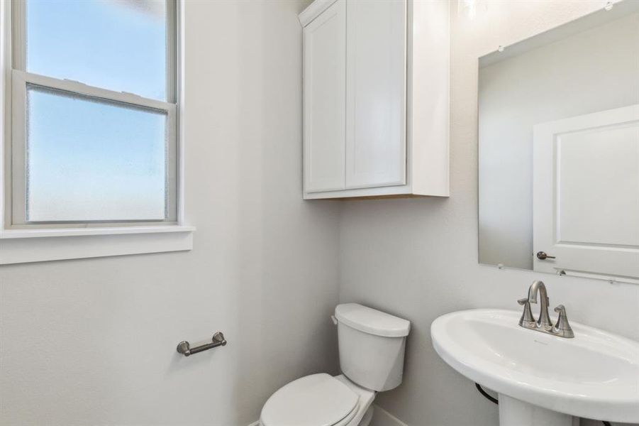 Bathroom featuring sink and toilet