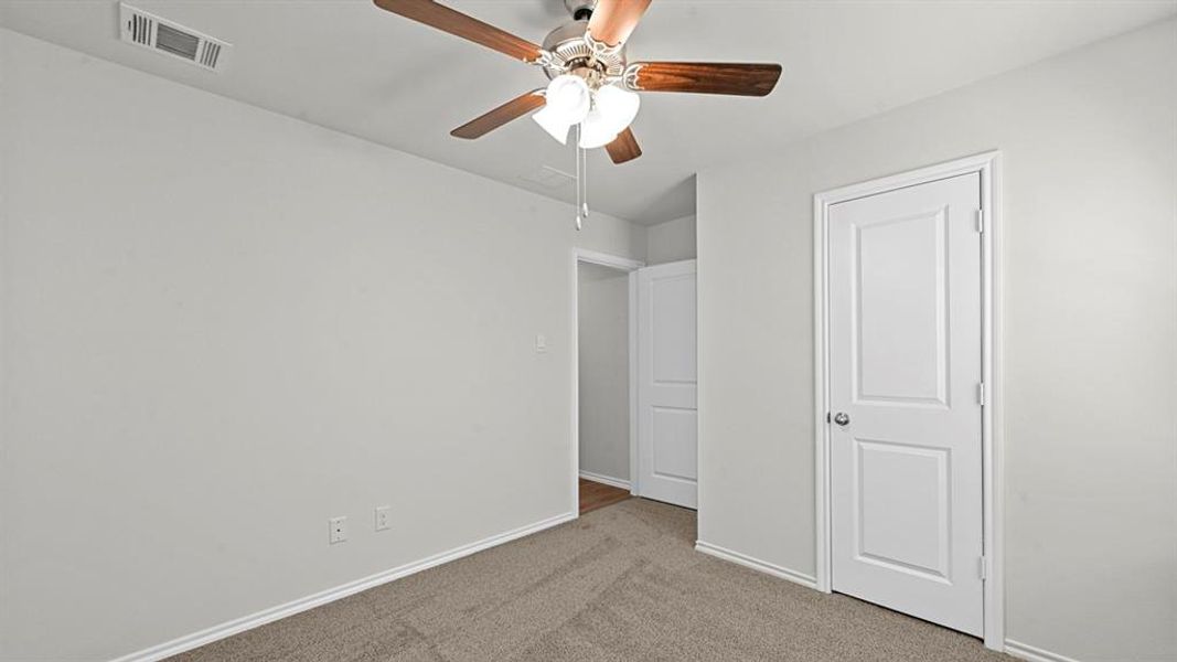 Unfurnished bedroom with carpet and ceiling fan