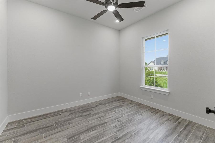 Neutral gray walls complement the wood-finish tile flooring