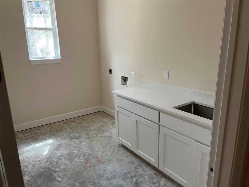 Laundry room is large, with storage closet, room for freezer, sink, counter and cabinets, will have tile floors. Laundry room is large, with storage closet, room for freezer, sink, counter and cabinets, will have tile floors.