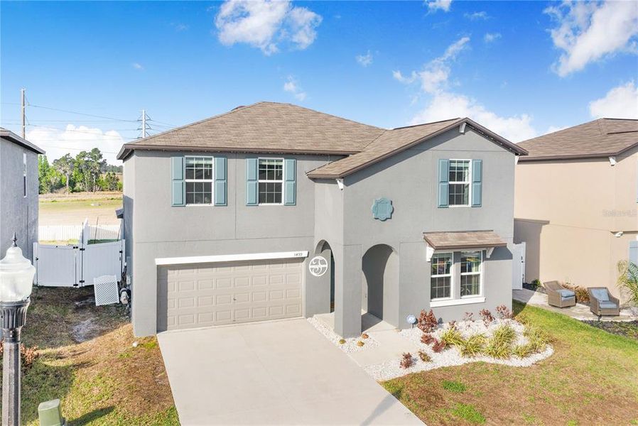 Front exterior of a new home in Wind Meadows South, Bartow, FL, highlighting curb appeal (Image 28).