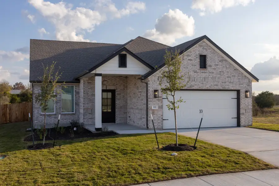 Front exterior of a new home in Village at Three Oaks, Seguin, TX, highlighting curb appeal (Image 1). Front exterior of a new home in Village at Three Oaks, Seguin, TX, highlighting curb appeal (Image 1).