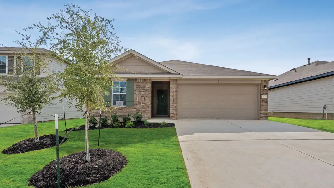 Front exterior of a new home in Carillon, Manor, TX, highlighting curb appeal (Image 1). Front exterior of a new home in Carillon, Manor, TX, highlighting curb appeal (Image 1).