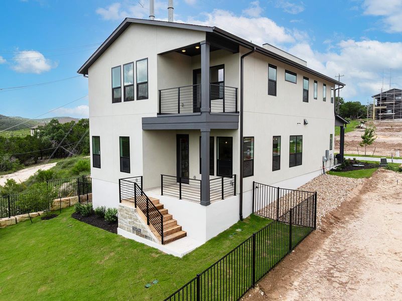 Rear view of home showing second story and downstairs decks