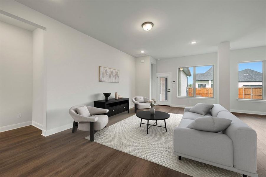 Living room featuring dark wood-style floors and recessed lighting