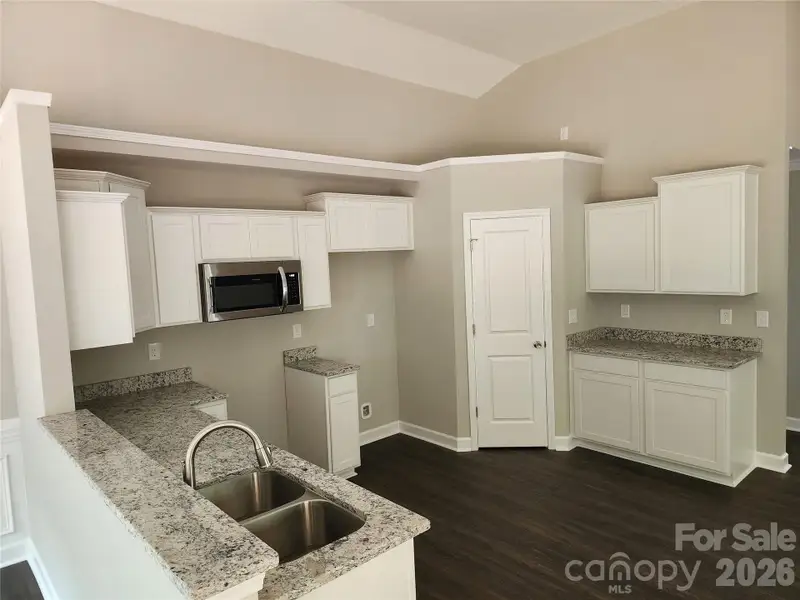 Decorative Kitchen w/ Granite Tops, SS Appliances and Walk in Pantry, Plant Shelf Above