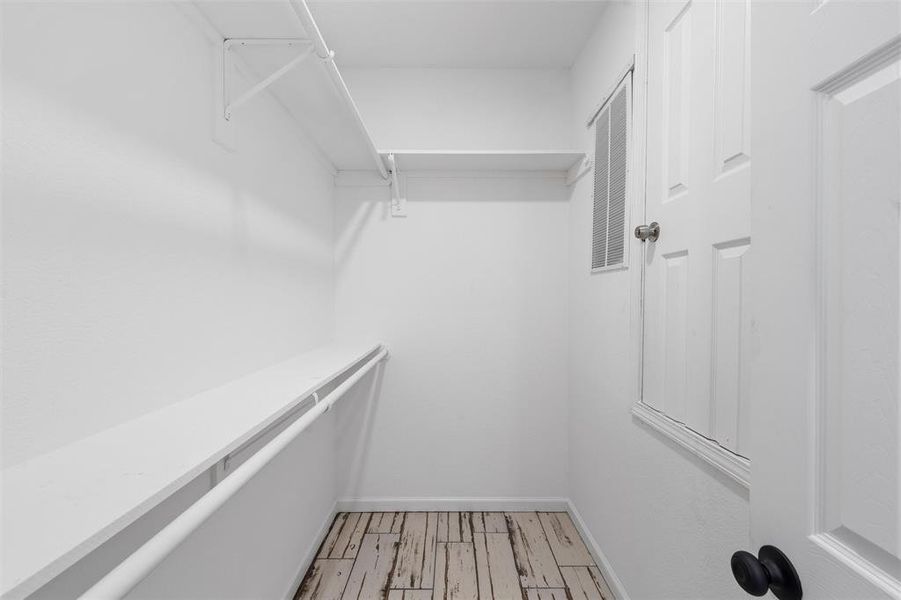 Walk in closet featuring light wood-style flooring Walk in closet featuring light wood-style flooring